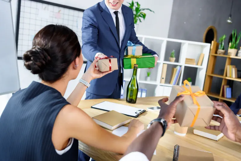 cropped-shot-of-businessman-presenting-gifts-to-co-2021-08-29-11-19-38-utc