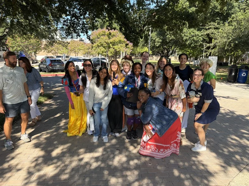 Hockaday School colleagues gather outdoors under the trees during their Dallas team Adventure.