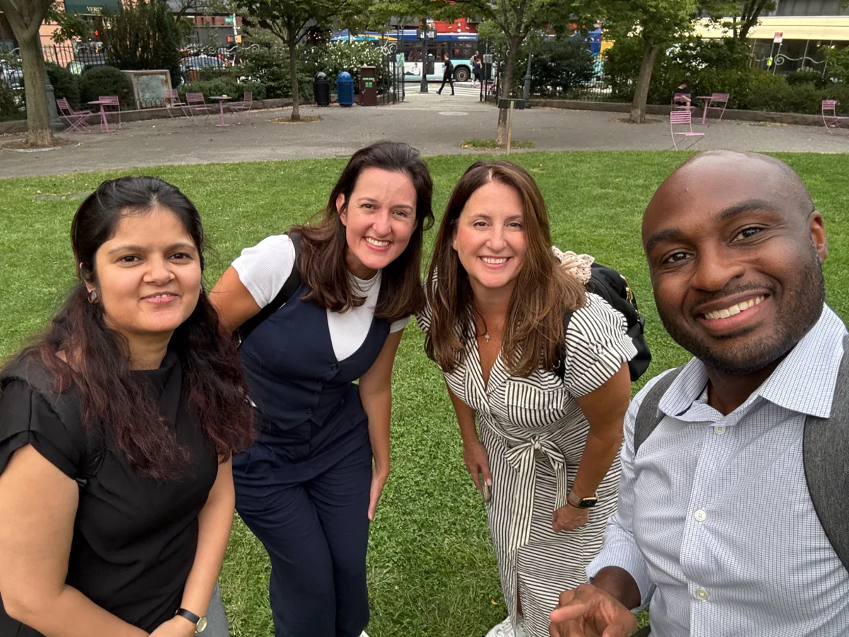 A Pfizer team poses together outdoors during its New York City Classic Adventure.