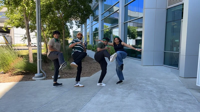 Google colleagues strike a playful team pose outdoors at their Sunnyvale campus Adventure.