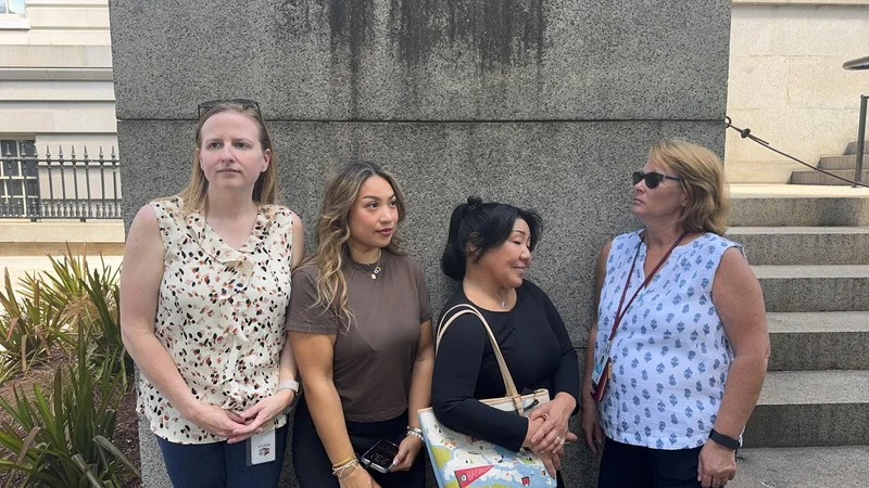 Wolf Greenfield teammates pose together outside during their Washington DC Chinatown Adventure.