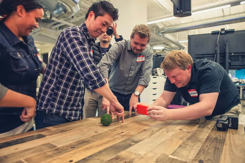 Colleagues collaborating on a hands-on team building challenge at a Go Game event